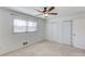 This bedroom offers neutral carpet, a ceiling fan, and bright, natural light at 2685 Whippoorwill Cir, Duluth, GA 30097