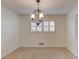 Bright dining room featuring a decorative chandelier, wainscoting and plush carpeting at 2685 Whippoorwill Cir, Duluth, GA 30097