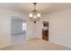 Bright dining room featuring a decorative chandelier and plush carpeting at 2685 Whippoorwill Cir, Duluth, GA 30097