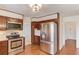 Traditional kitchen with stainless steel appliances, wood cabinets, and hardwood floors at 2685 Whippoorwill Cir, Duluth, GA 30097