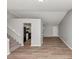 Open living room view showcasing new wood flooring, staircase, and kitchen access at 3671 Satellite Blvd, Ellenwood, GA 30294