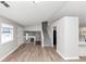 Light-filled living room featuring modern flooring, staircase, and entry to kitchen at 3671 Satellite Blvd, Ellenwood, GA 30294