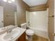 Bathroom featuring a shower-tub combo, toilet, sink with cabinet, and mirror at 3756 Brookwood Blvd, Rex, GA 30273