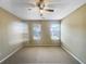 Neutral toned bedroom with carpet and two windows providing natural light and ventilation at 3756 Brookwood Blvd, Rex, GA 30273