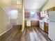 Efficient kitchen layout featuring white appliances, wood cabinetry, and vinyl floors at 3756 Brookwood Blvd, Rex, GA 30273