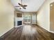 Inviting living room featuring a fireplace, ceiling fan, and stylish dark hardwood flooring at 3756 Brookwood Blvd, Rex, GA 30273