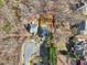 Aerial view showing a home, landscaping, circular drive and mature trees in a neighborhood on a sunny day at 1811 Penny Nw Ln, Lawrenceville, GA 30043