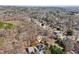 An aerial shot shows the house with mature landscaping, well-maintained lawns, and the surrounding wooded neighborhood at 1811 Penny Nw Ln, Lawrenceville, GA 30043