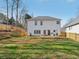 The backyard features a level grassy area, a wood fence, and a patio area, offering space for outdoor enjoyment at 1811 Penny Nw Ln, Lawrenceville, GA 30043