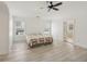 Expansive bedroom with tray ceiling, hardwood floors, ceiling fan, and natural light from two large windows at 1811 Penny Nw Ln, Lawrenceville, GA 30043