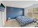 Comfortable bedroom with blue accent wall, neutral floors, and a window letting in natural light at 1811 Penny Nw Ln, Lawrenceville, GA 30043