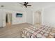 Large primary bedroom featuring tray ceilings, a ceiling fan, and hardwood floors for a relaxing retreat at 1811 Penny Nw Ln, Lawrenceville, GA 30043