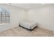 Minimalist bedroom with wood-look flooring, a window, and simple furnishings offering a serene space at 1811 Penny Nw Ln, Lawrenceville, GA 30043