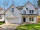 Charming white two-story home with a well-maintained front yard and attached two-car garage at 1811 Penny Nw Ln, Lawrenceville, GA 30043