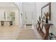 Bright foyer with light wood flooring, a console table, and an open view of the home at 1811 Penny Nw Ln, Lawrenceville, GA 30043