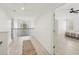 Bright hallway with wood floors, railing, and view to a sunlit bedroom and arched window at 1811 Penny Nw Ln, Lawrenceville, GA 30043
