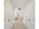 Bright hallway featuring white walls and doors, archway, and hardwood floors leading to the bedroom at 1811 Penny Nw Ln, Lawrenceville, GA 30043