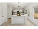 Well-lit kitchen features a central island, modern lighting, white cabinetry, and stainless steel appliances at 1811 Penny Nw Ln, Lawrenceville, GA 30043