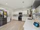 Well-lit kitchen featuring stainless steel appliances, white cabinets, and a modern design at 1811 Penny Nw Ln, Lawrenceville, GA 30043