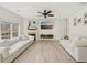 Bright living room featuring a fireplace, comfortable seating, and light-colored wood floors at 1811 Penny Nw Ln, Lawrenceville, GA 30043