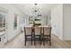 Open-concept living area with a kitchen island, modern decor, and plenty of natural light at 1811 Penny Nw Ln, Lawrenceville, GA 30043