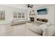 Cozy living room featuring a fireplace, plush sectional sofa, and a ceiling fan at 1811 Penny Nw Ln, Lawrenceville, GA 30043