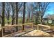 A wood deck with black railings offers views of the backyard and surrounding trees at 3184 Pinto Dr, Powder Springs, GA 30127