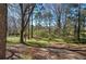 The backyard features mature trees and a partially cleared space at 3184 Pinto Dr, Acworth, GA 30127