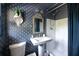 Charming bathroom with patterned wallpaper, pedestal sink, and a shower with curtain at 4323 E Durham Cir, Stone Mountain, GA 30083