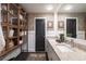 Modern bathroom features double sinks, granite counters, cabinet, and patterned wallpaper at 4323 E Durham Cir, Stone Mountain, GA 30083