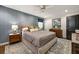 Comfortable bedroom features a ceiling fan, textured wallpaper, and a luxurious bed at 4323 E Durham Cir, Stone Mountain, GA 30083