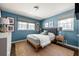 Serene blue bedroom with natural light, calm color palette, and hardwood floors at 4323 E Durham Cir, Stone Mountain, GA 30083