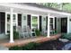 Close-up of a cozy front porch, furnished with rocking chairs and potted plants at 4323 E Durham Cir, Stone Mountain, GA 30083