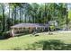 Beautiful brick home featuring a well-manicured lawn and lush landscaping at 4323 E Durham Cir, Stone Mountain, GA 30083