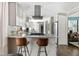 Modern kitchen with stainless steel appliances, white cabinetry, and counter seating at 4323 E Durham Cir, Stone Mountain, GA 30083