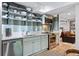 Modern kitchenette features stainless steel appliances, open shelving, and stylish design at 4323 E Durham Cir, Stone Mountain, GA 30083