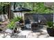 A modern patio with comfortable seating area surrounded by a garden and a privacy fence at 4323 E Durham Cir, Stone Mountain, GA 30083