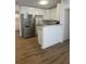 Modern kitchen with stainless steel appliances, white cabinets and wood-look floor at 2041 Olive Springs Se Rd, Marietta, GA 30060