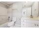 This bathroom features a shower-tub combination, tiled floor, and a sink with a vanity at 385 Sweet Ivy Ln, Lawrenceville, GA 30043