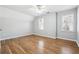 Bright bedroom featuring wood floors, neutral paint, modern ceiling fan, and multiple windows at 385 Sweet Ivy Ln, Lawrenceville, GA 30043