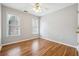 This bedroom features wood floors, neutral paint, and two windows for natural light at 385 Sweet Ivy Ln, Lawrenceville, GA 30043