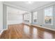 Elegant dining room with hardwood floors, crown molding, and large windows for natural light at 385 Sweet Ivy Ln, Lawrenceville, GA 30043