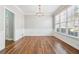 Dining room featuring hardwood floors, white walls and trim, with natural light from a large window at 385 Sweet Ivy Ln, Lawrenceville, GA 30043