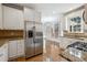 Bright kitchen with stainless steel appliances, granite countertops, and white cabinetry at 385 Sweet Ivy Ln, Lawrenceville, GA 30043