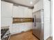 Well-lit kitchen features stainless steel fridge, granite counters, and white cabinets at 385 Sweet Ivy Ln, Lawrenceville, GA 30043