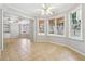 Living room with tile flooring, many windows, and a ceiling fan at 385 Sweet Ivy Ln, Lawrenceville, GA 30043