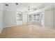 Living room features built-in shelving, a tray ceiling, tile floors, and many windows at 385 Sweet Ivy Ln, Lawrenceville, GA 30043