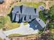 Aerial view of modern farmhouse showcasing roofline, detached garage, circular driveway, and outdoor fire pit at 441 Pumpkinvine Rd, Acworth, GA 30101