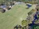 Picturesque aerial view of a sprawling property with a pond, lush fields, and a home nestled among mature trees at 441 Pumpkinvine Rd, Acworth, GA 30101