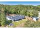 Overhead view of a vast property, home, guesthouse, outdoor firepit, and verdant landscape at 441 Pumpkinvine Rd, Acworth, GA 30101
